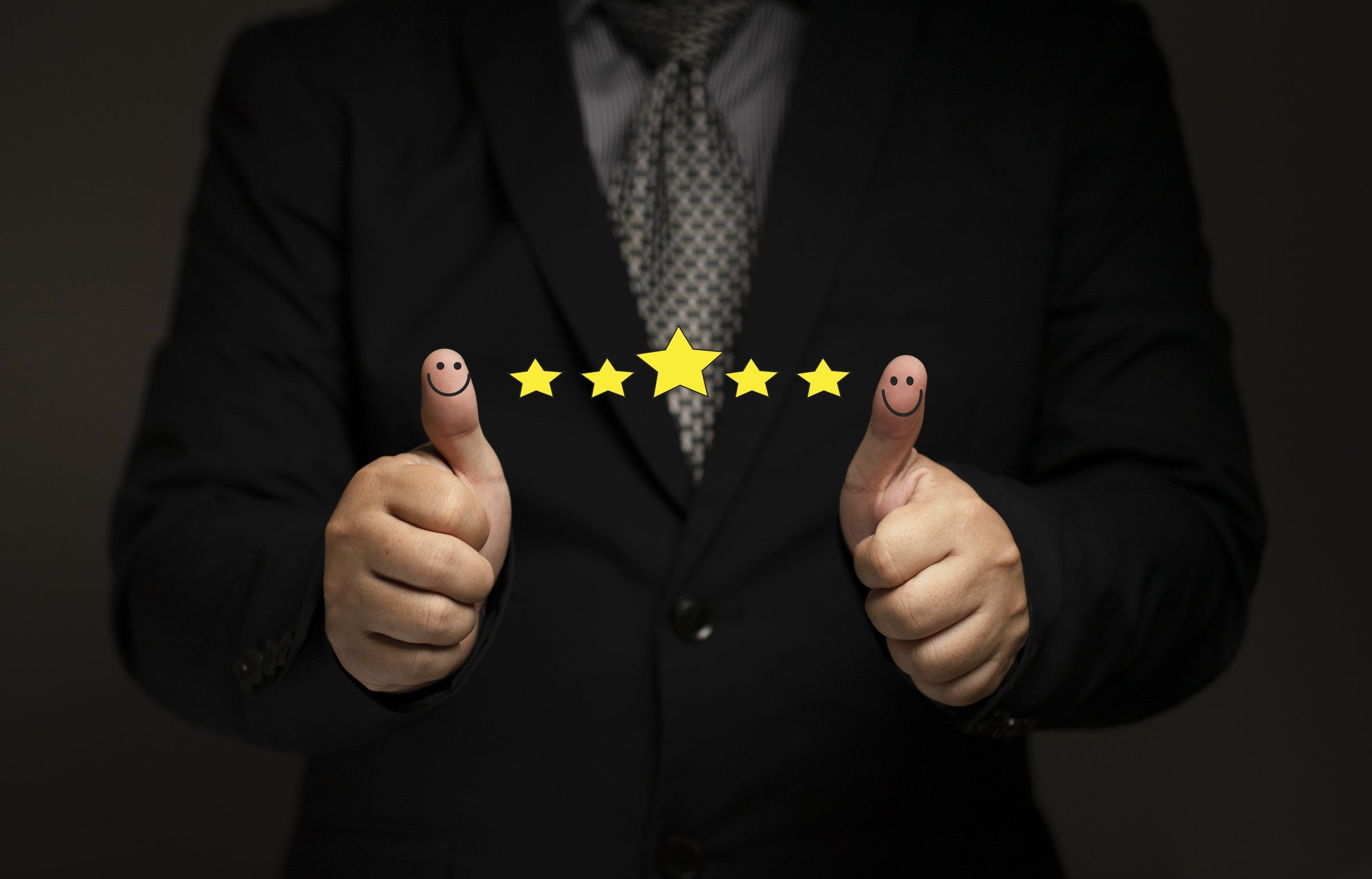 Suited businessman giving the thumbs up
