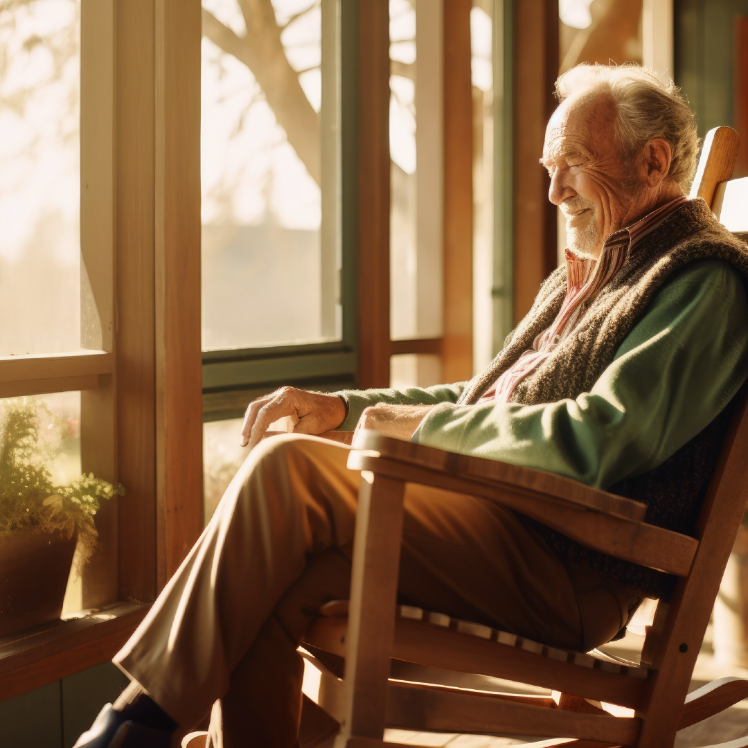 A senior citizen sitting in a chair at a retirement home